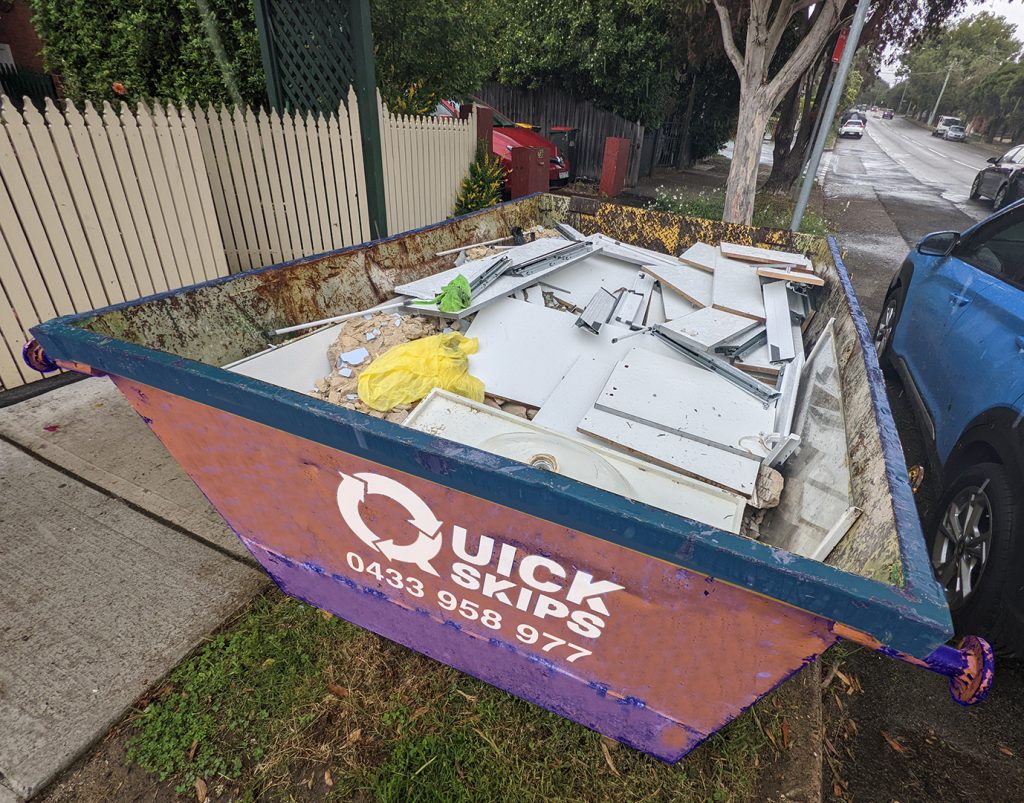 small 3 cubic metre skip bin hire with rear door filled with rubbish Fairfield area and Smithfield
