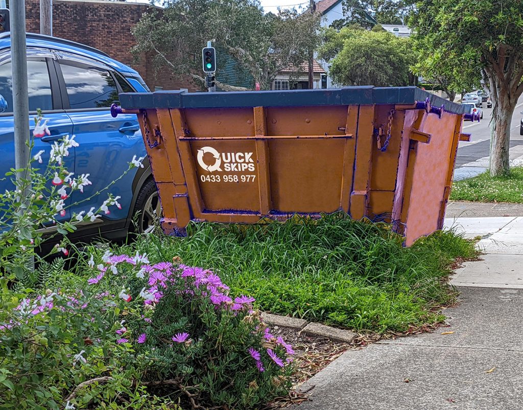 Three cubic metre skip bin hire with rear door filled with rubbish small enough to fit on the verge Fairfield area Smithfield, Guildford