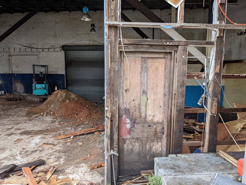 Early stages of demolition, 10m3 hook skip bin for construction